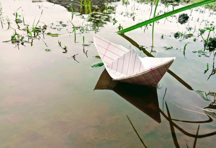 Barco de papel sobre el agua.